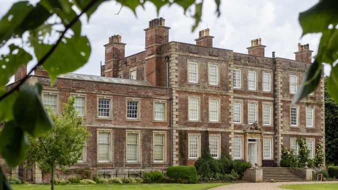 Gunby Hall surrounded by greenery.